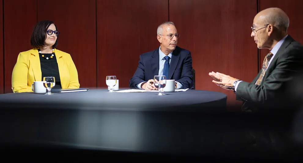Three panel members having a discussion
